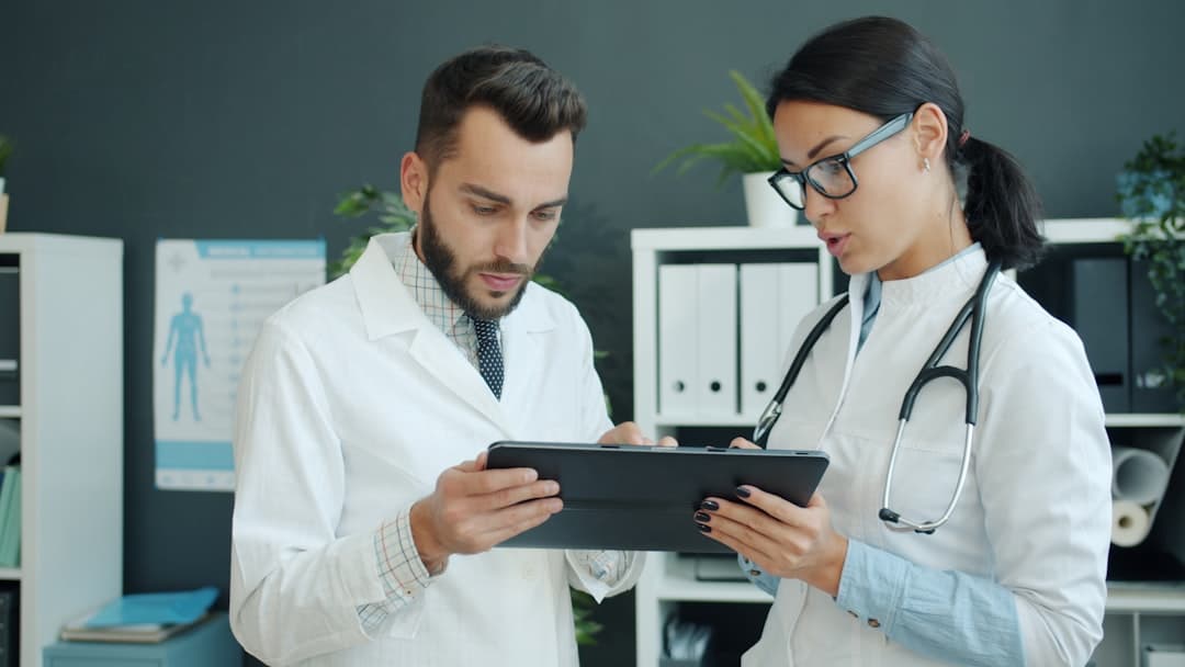 A physician using a tablet to manage their practice digitally